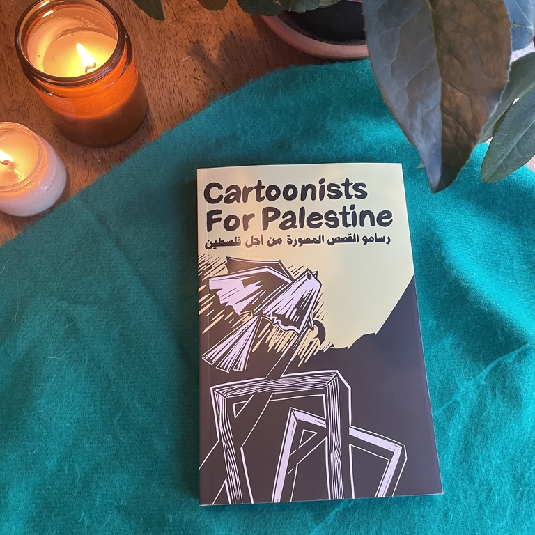 The cartoonists for palestine book next to candles