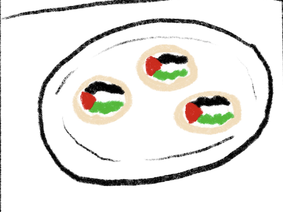 a plate of cookies decorated with the Palestinian flag