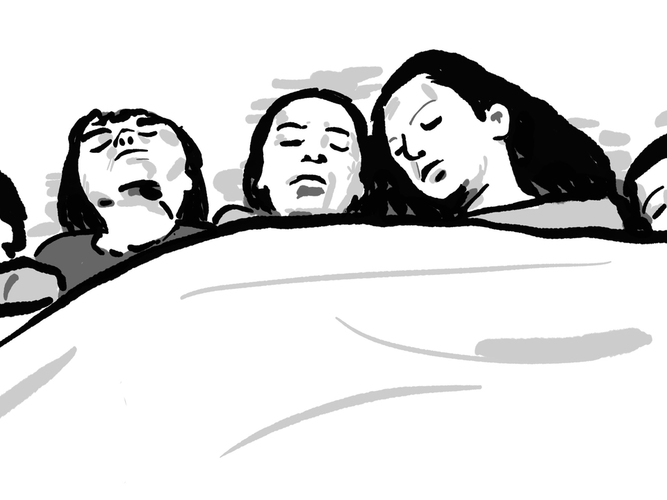 a family of people sleeping in bed